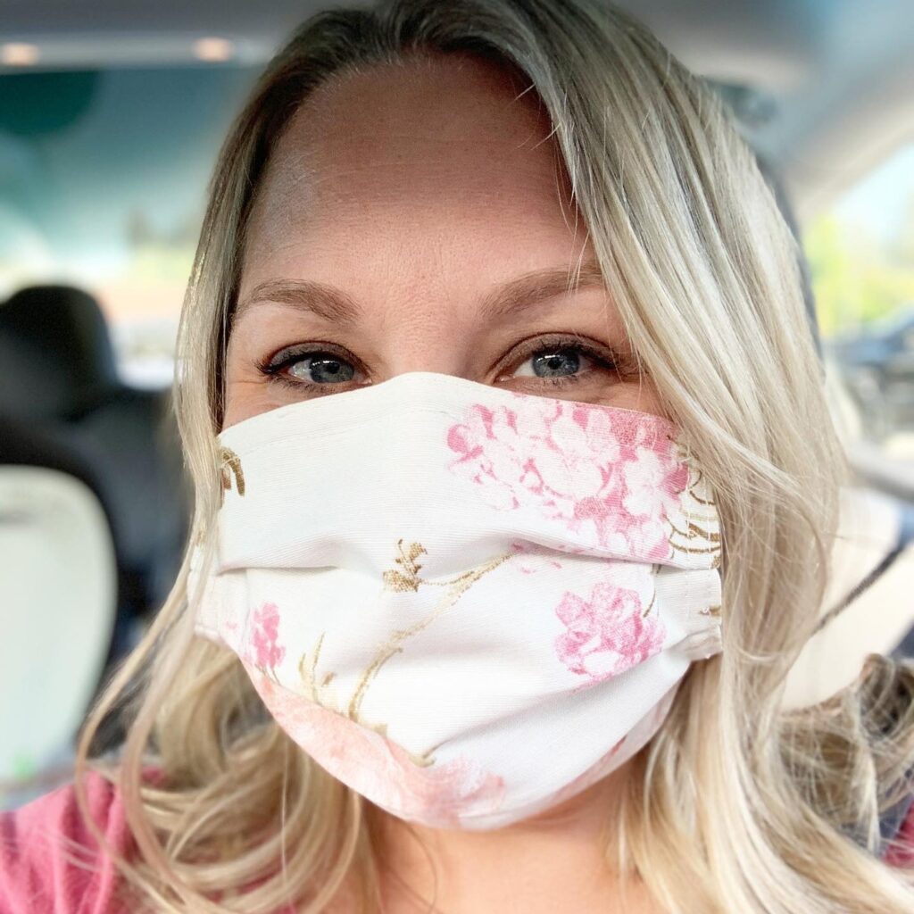 Alena wears a pink and white cloth face mask