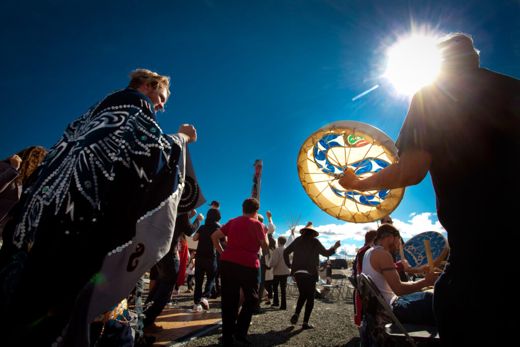 People drumming, singing and dancing in the sun